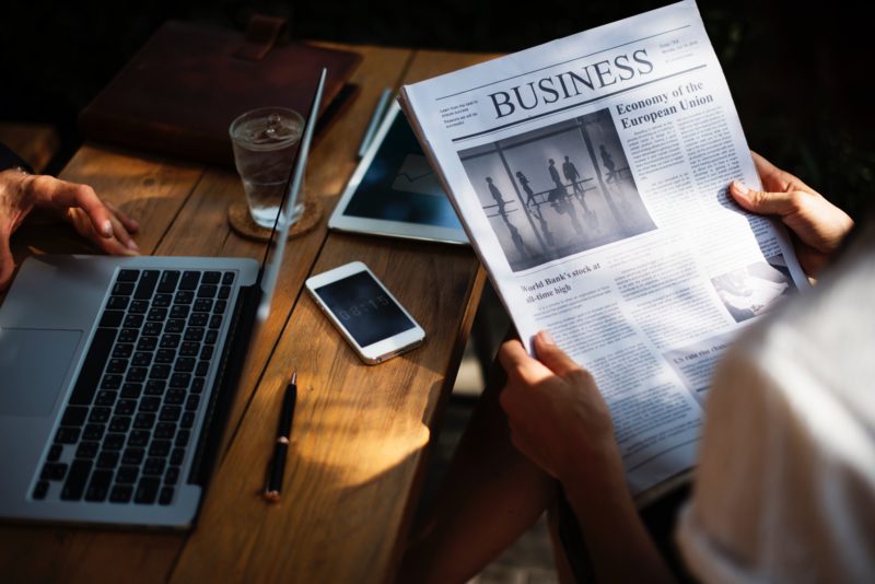 man reading business newspaper