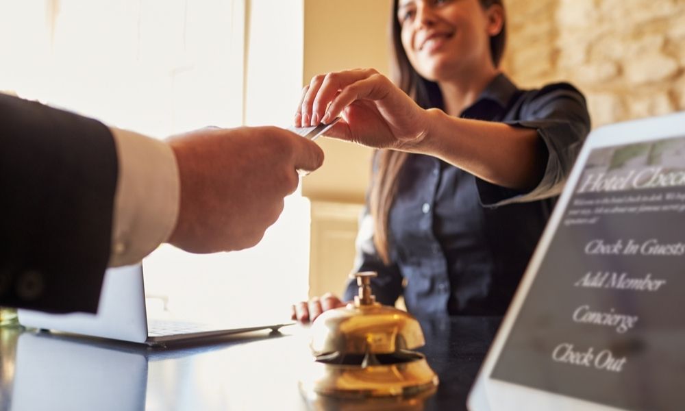 Lady receptionist providing card access to customer